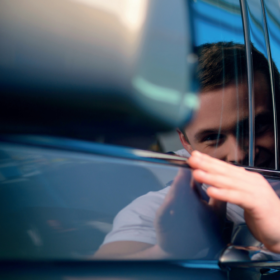 Image of man touching a car bodywork